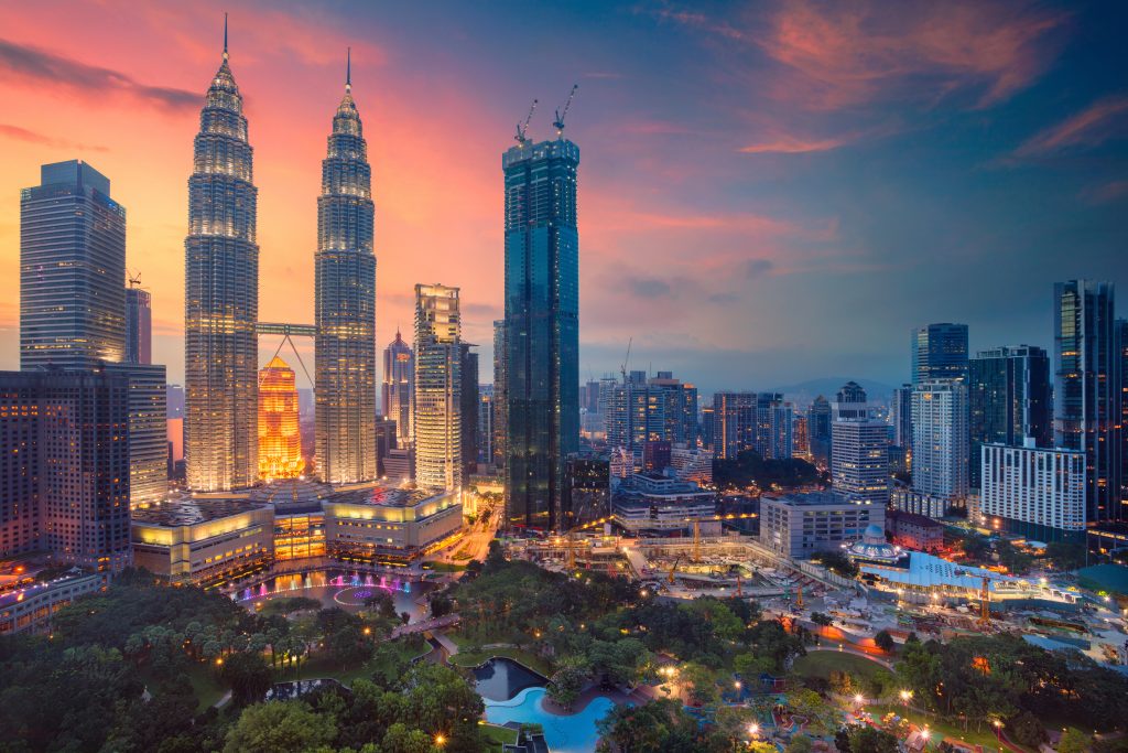 Sunset with the city skyline of one of the cheapest destinations to fly to out of Australia - Kuala Lumpur, Malaysia.